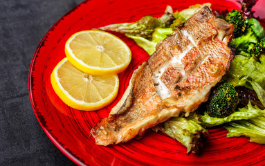 Steamed snapper (pacific ocean perch, sea bass, ruby perch) with soy sauce, lemon, ginger and parsley in Asian style. Healthy cooking