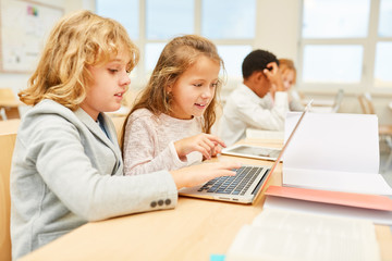 Kinder arbeiten zusammen am Laptop