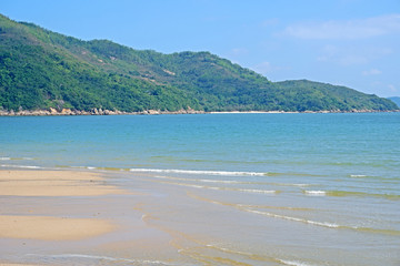 Obraz premium Beach, sea with wave, mountain and blue sky