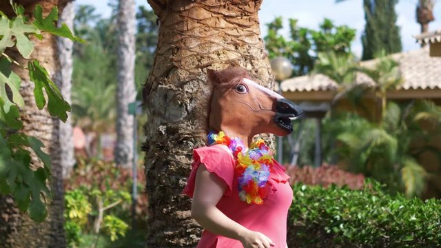 Woman in a horse mask showing okay in 4k slow motion 60fps