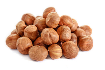 Peeled hazelnuts on a white background. Isolated hazelnut. Without shells.