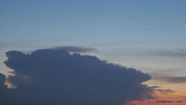 Detail of thunderbolt lightning behind dark cloud, colorful evening sky, beauty 