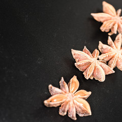 Asian spices, Star anise spice fruits and seeds isolated on black background closeup