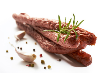 Sausage with herbs and spices on a white background