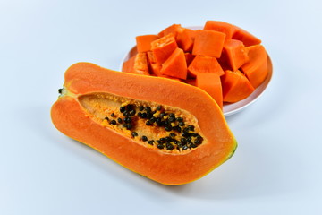 Slices of papaya on white background.