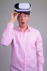 Portrait of shocked young businessman with virtual reality headset