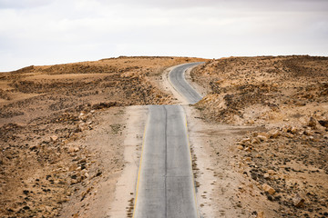 Fototapeta na wymiar Kings highway, beautiful curvy road running through the Wadi Rum desert in Jordan.