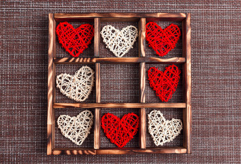 Valentine's day background with hearts in the wooden box on sackcloth and cell copy space.