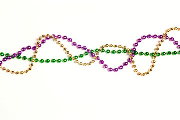 Mardi Gras three colours beads on white background. © WindyNight