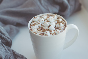Cocoa with marshmallows on a cozy gray background