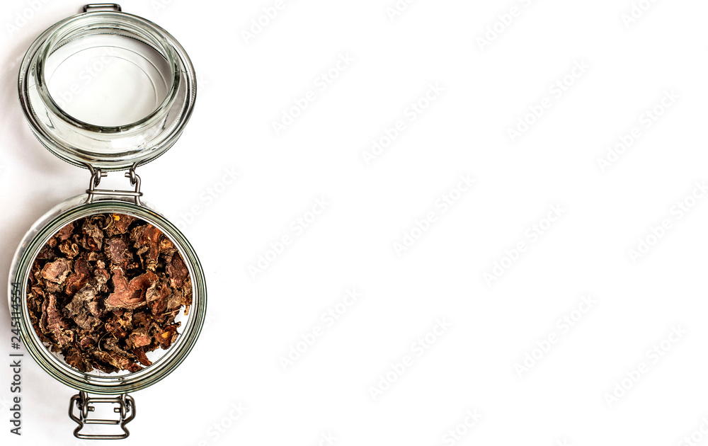 Wall mural cut dry root of Rhodiola rosea in a glass jar on natural white background