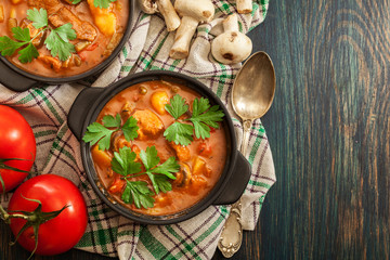 Stew soup with meat, potatoes, mushrooms and red pepper