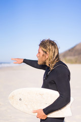 surfer with flippers and a bodyboard in a hydro suit on the ocean shore