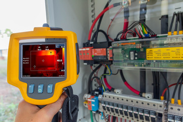 Thermoscan(thermal image camera), Industrial equipment used for checking the internal temperature of the machine for preventive maintenance - obrazy, fototapety, plakaty