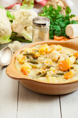 Vegetable soup with ingredients carrot, cauliflower, potato and parsley