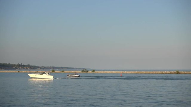Power Boat And Speed Boat Pulling Into Dock