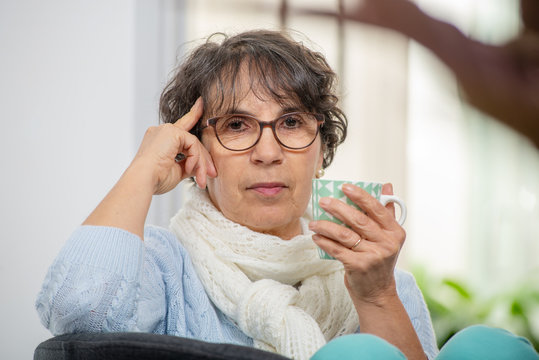 Portrait Of Senior Brunette With Blue Sweater