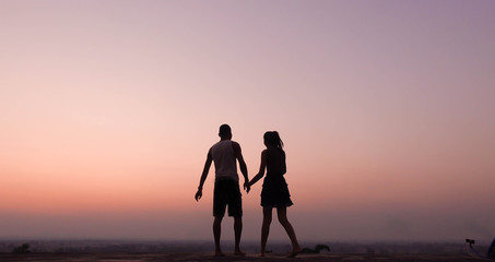 silhouette of couple feel happy  at sunset
