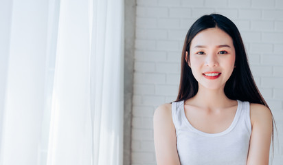 Portrait of Young Beautiful Asian woman clear face skincare her happy and smile at white room.