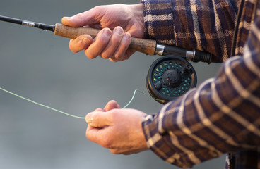 Hands tying flies and casting close up