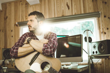 Handsome young man playing guitar. Musician playing Spanish guitar