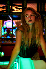 Beautiful blond woman in arcade, looking away