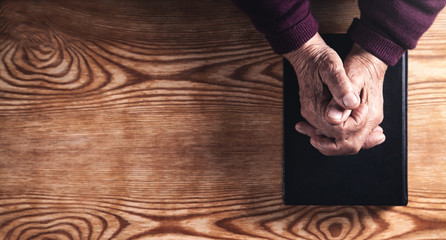 Hands of elderly woman praying. Religion concept