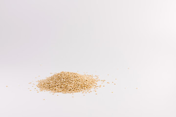 Pile of quinoa seeds isolated on a white background