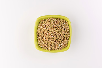 Natural fresh green buckwheat in bowl isolated on white background.