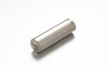 Universal silver battery on white background with reflection