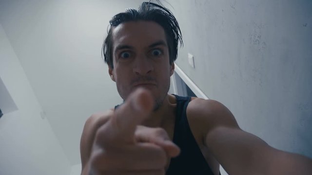 aggressive man screams hard and brutally beats lying opponent