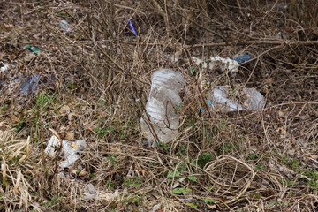 Garbage in forest. People illegally throw garbage into forest. Concept of man and nature. Illegal garbage dump in nature. Dirty environment garbage polluting near footpath in forest. Rubbish, trash