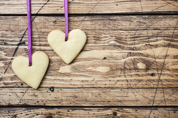 Heart shaped cookies for valentine's day on wooden background. Copy space