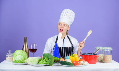 Cooking is her hobby. Cooking healthy food. Girl in hat and apron. Woman chef cooking healthy food. Fresh vegetables ingredients for cooking meal. Delicious recipe concept. Gourmet main dish recipes