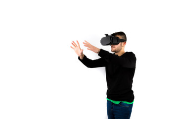 Bearded Young nice and modern with vr glasses that enjoy virtual reality with simulator touching something virtual isolated over white background