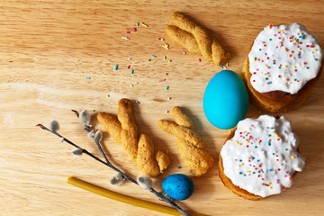 Traditional Easter homemade cookies in the shape of bunny ears, Easter cakes with sweet icing and...