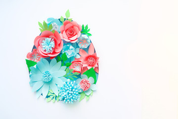 Easter egg made of paper flowers on white background. Cut from paper.