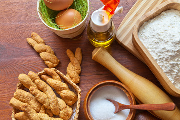 Top view of the kitchen table with products for making homemade Easter cookies in the form of bunnies