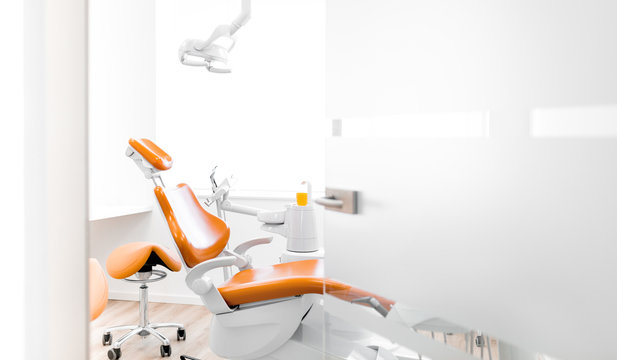 Behandlungsraum beim Zahnarzt mit orange farbenen Stühlen