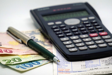 Turkish lira banknotes calculator bills and tax calculations on isolated background