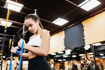 Fototapeta na wymiar Beautiful young girl professional trainer is preparing for a competition and is known in the gym. The concept of a healthy lifestyle and professional sports career