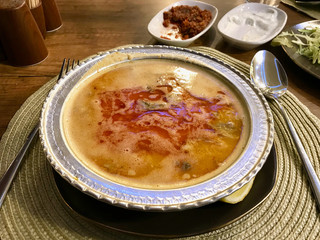 Turkish Soup Beyran with Lamb Meat, Rice, Chopped Garlic and Vinegar Sauce Served with Salad.