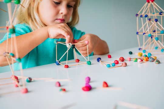 little girl making geometric shapes, engineering and STEM