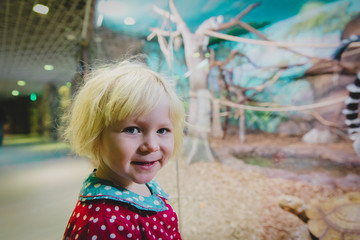 cute little girl enjoy trip to the zoo, looking at animals