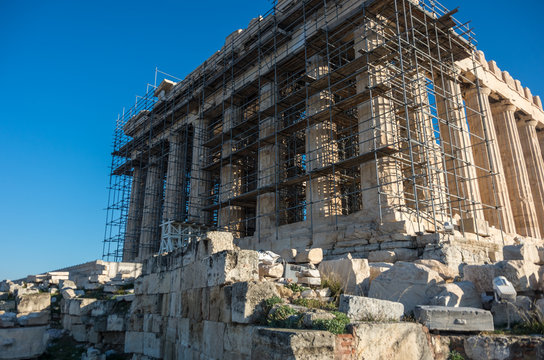 Parthenon temple in restoration scaffold  on a bright day. Acropolis in Athens, Greece