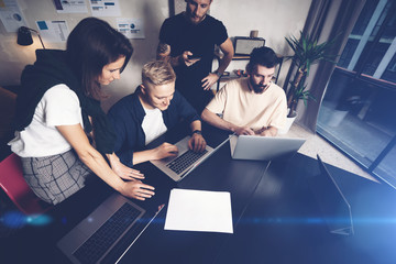 Coworkers team at work. Group of young business people in trendy casual wear working together in...
