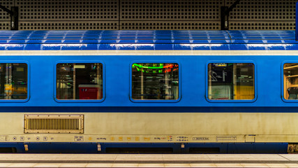 blue subway car is on the platform