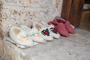 Kruje, Albania - June 2018: Traditional Ottoman market in Kruja, birth town of National Hero Skanderbeg. Flea market in Albania. Wool craft souvenirs for sale.