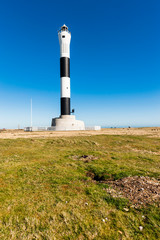 Fototapeta na wymiar The newer Lighthouse in Dungeness, Kent, England