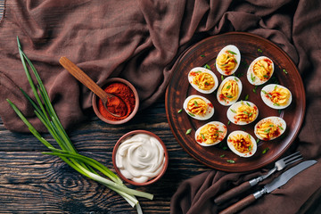 Deviled Eggs sprinkled with paprika and greens